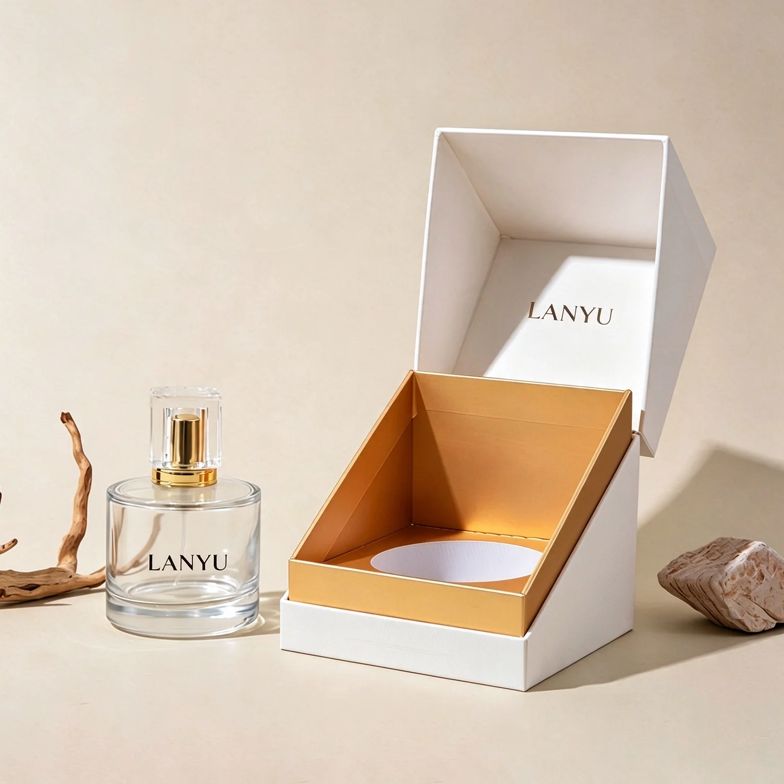 White open perfume box with gold-colored insert beside a perfume bottle