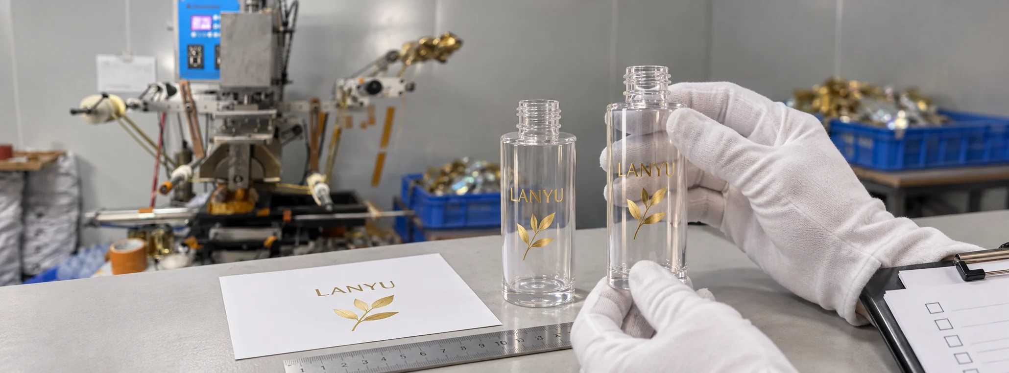 Reviewing gold-colored bottle artwork against a printed reference